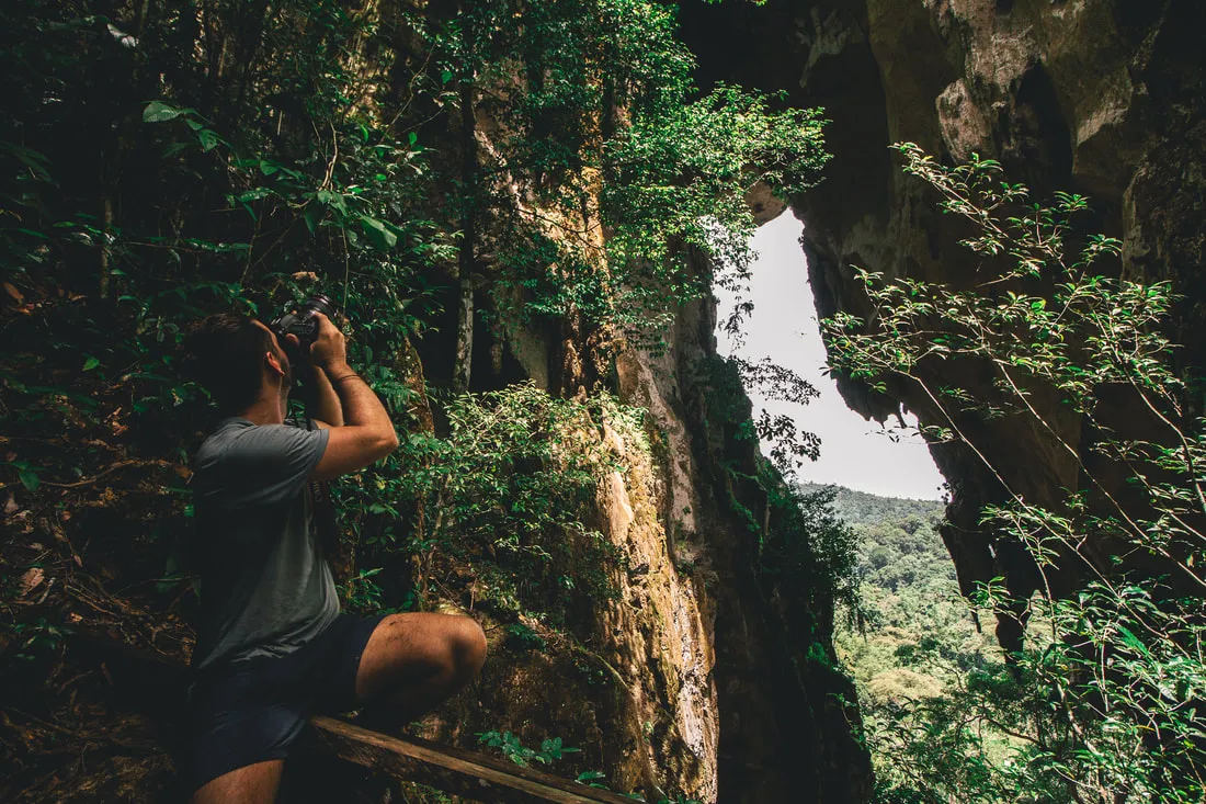 Guest photographing the cave mouth at Pungiton Cave