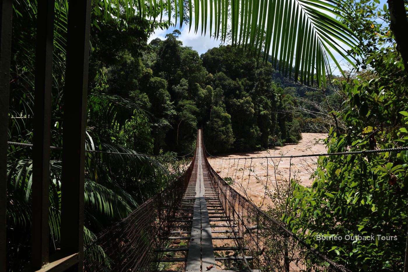 Suspension bridge over a wild jungle river in the Sapulot interior beyond Keningau, Sabah
