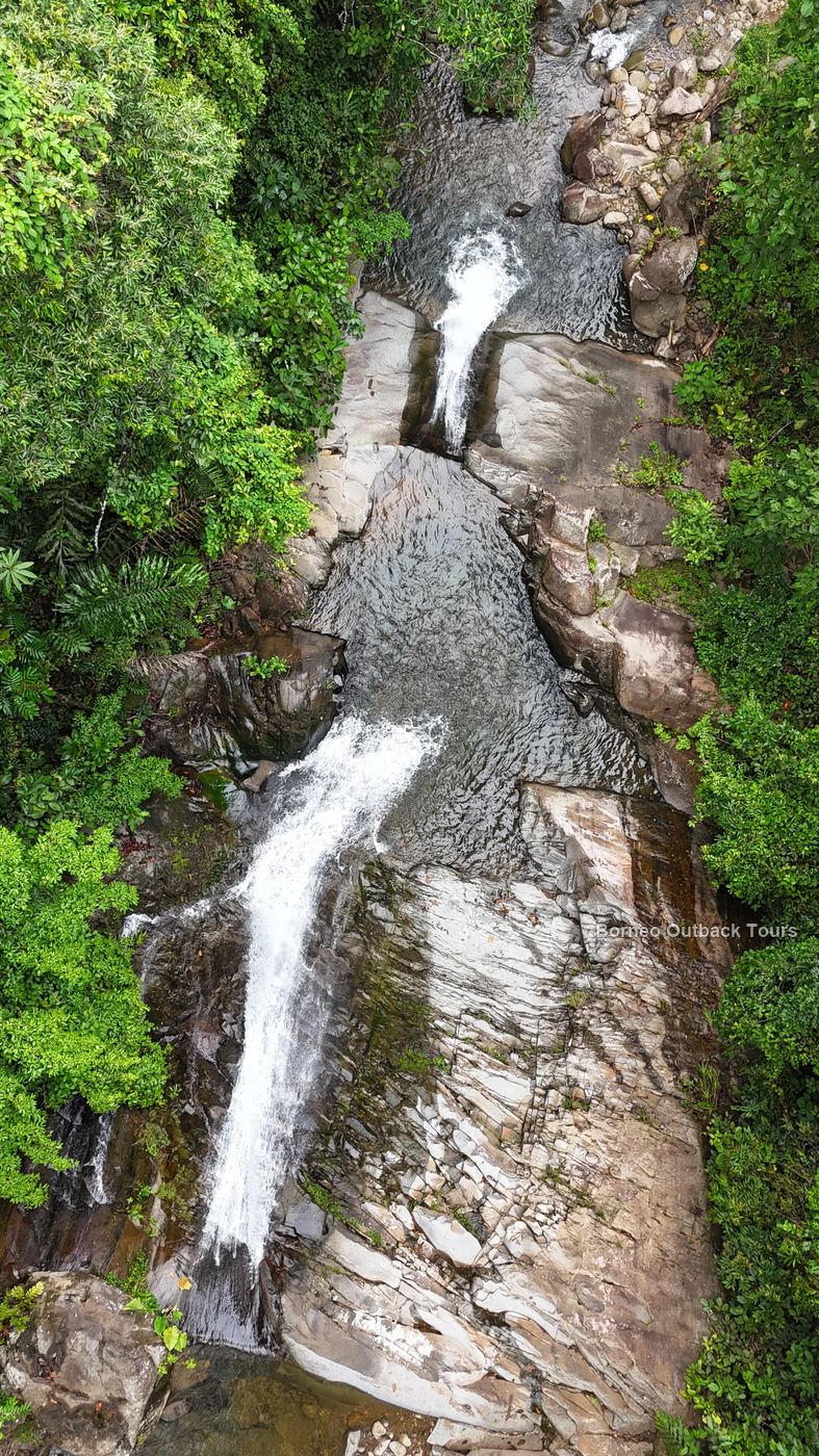 Looking out from the top of Kabulongou Waterfall across the rainforest of Sabah's interior, Borneo