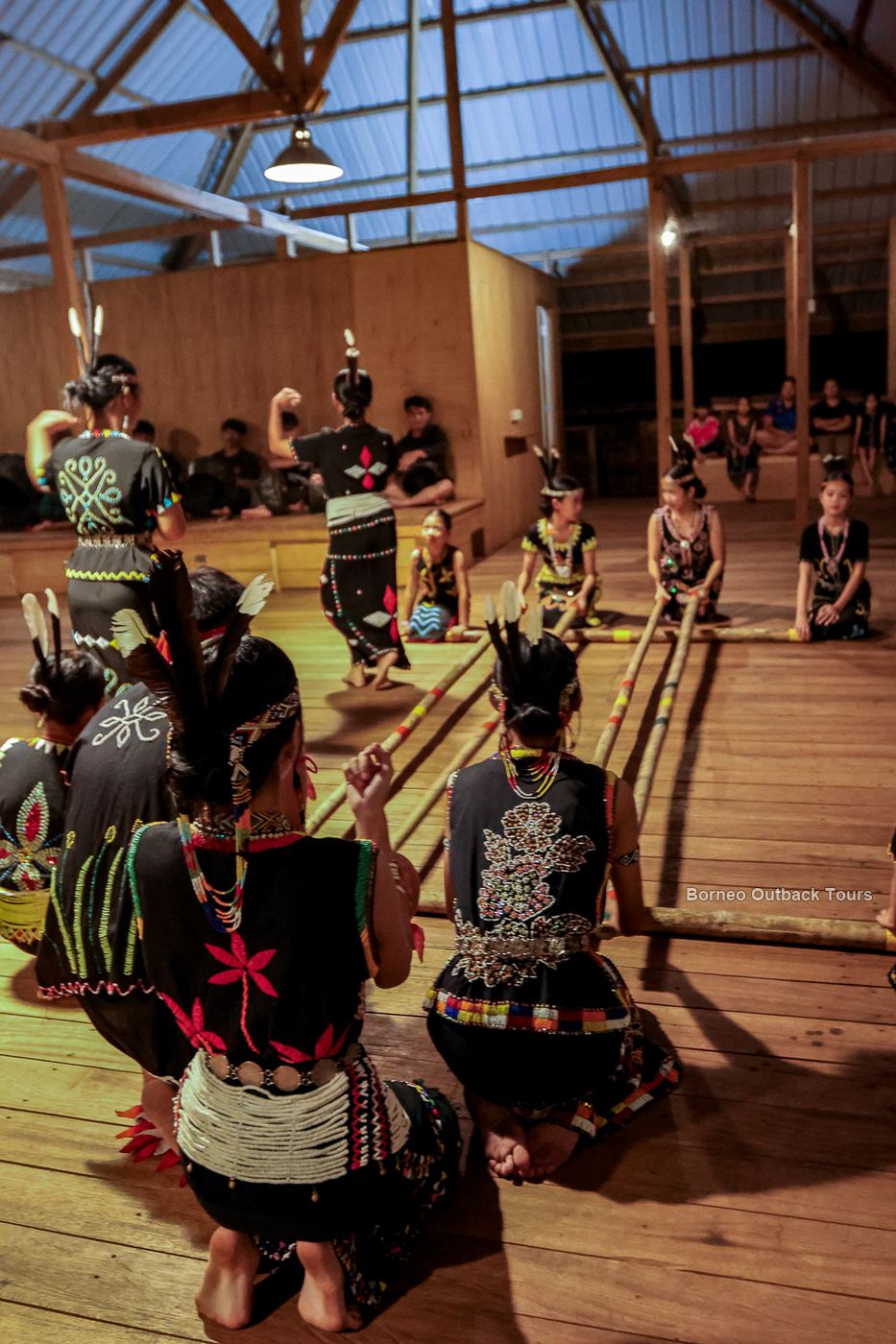 Murut dancers in traditional dress performing the Magunatip bamboo dance at a cultural night in Sapulot, Sabah