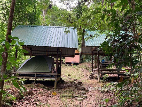 A traditional hut at Vangkaakon eco-camp beside the river in Sapulot, an overnight stop on a Sabah itinerary